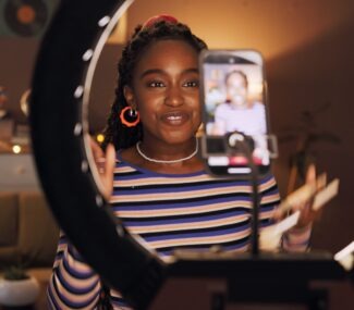 black,woman,,influencer,and,phone,with,ring,light,at,house
